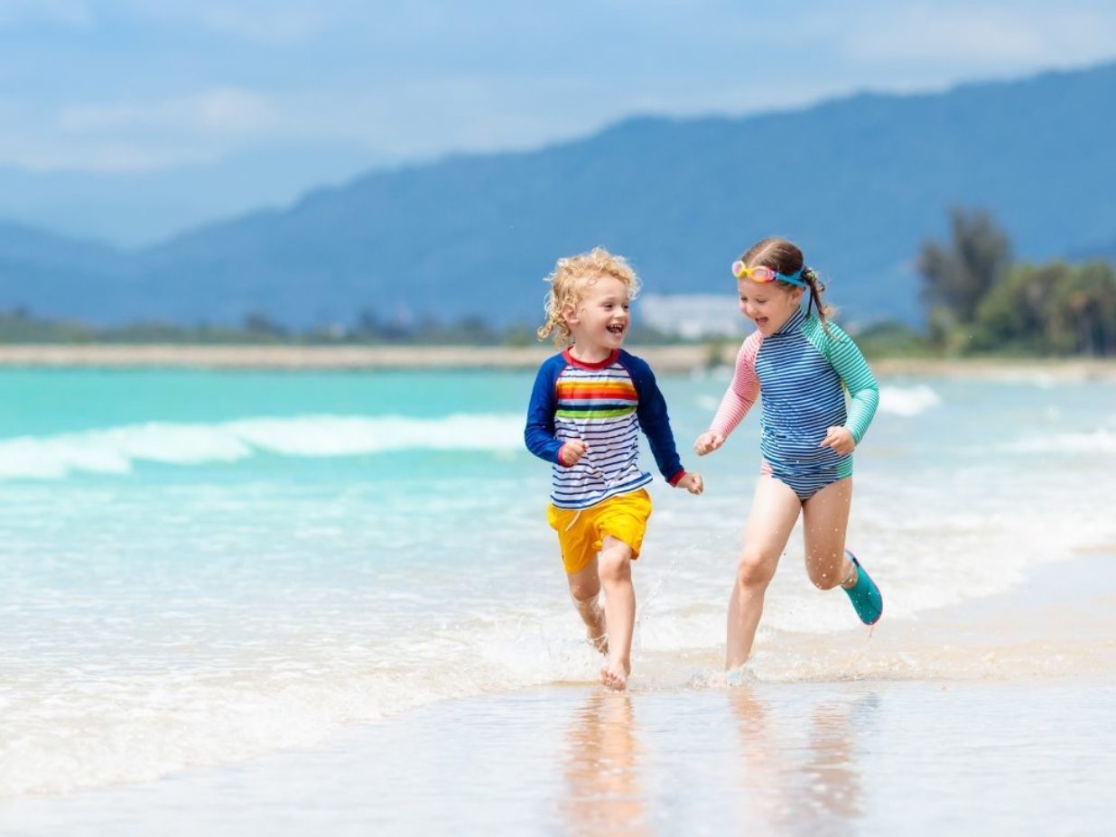 dzieci biegną po plaży